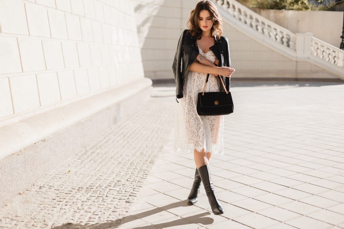 Home Young Stylish Woman Walking Street Fashionable Outfit Holding Purse Wearing Black Leather Jacket White Lace Dress Spring Autumn Style Posing High Leather Boots 1